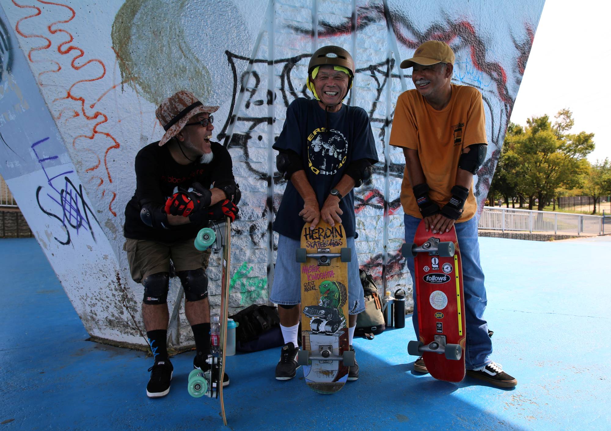 Yoshio Kinoshita (center) says he recommends skateboarding as a way to keep dementia at bay. | REUTERS