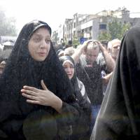 Iranians attend the funeral of victims of Wednesday\'s Islamic State militant attack in Tehran on Friday. | AP